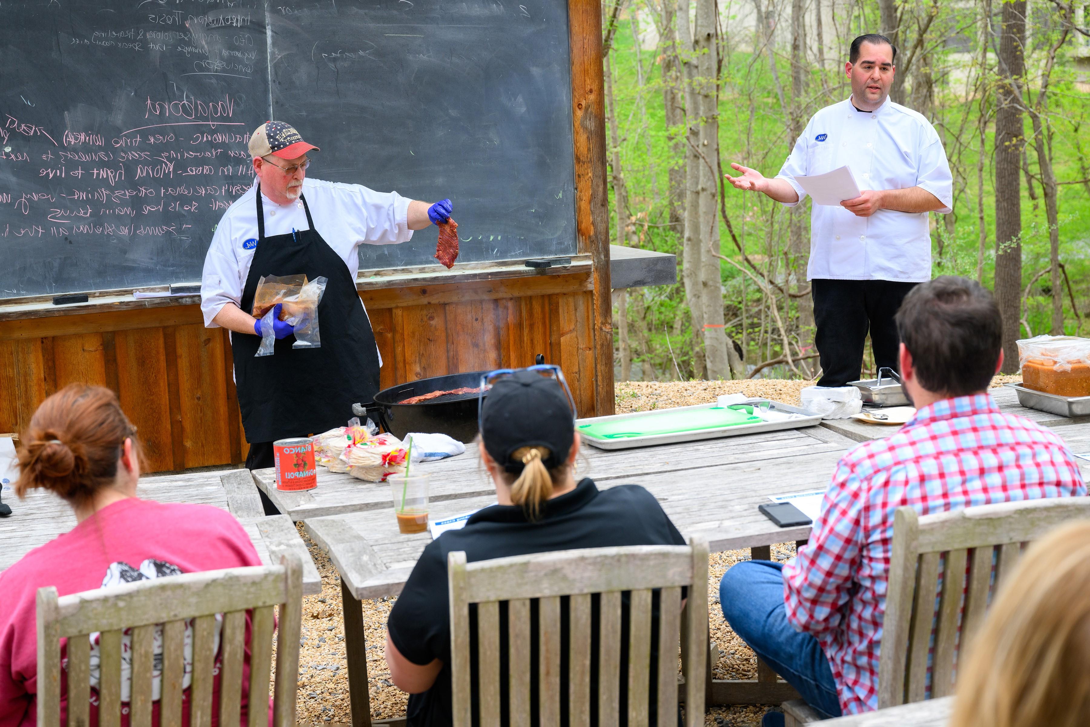 Employees take part in a grilling class