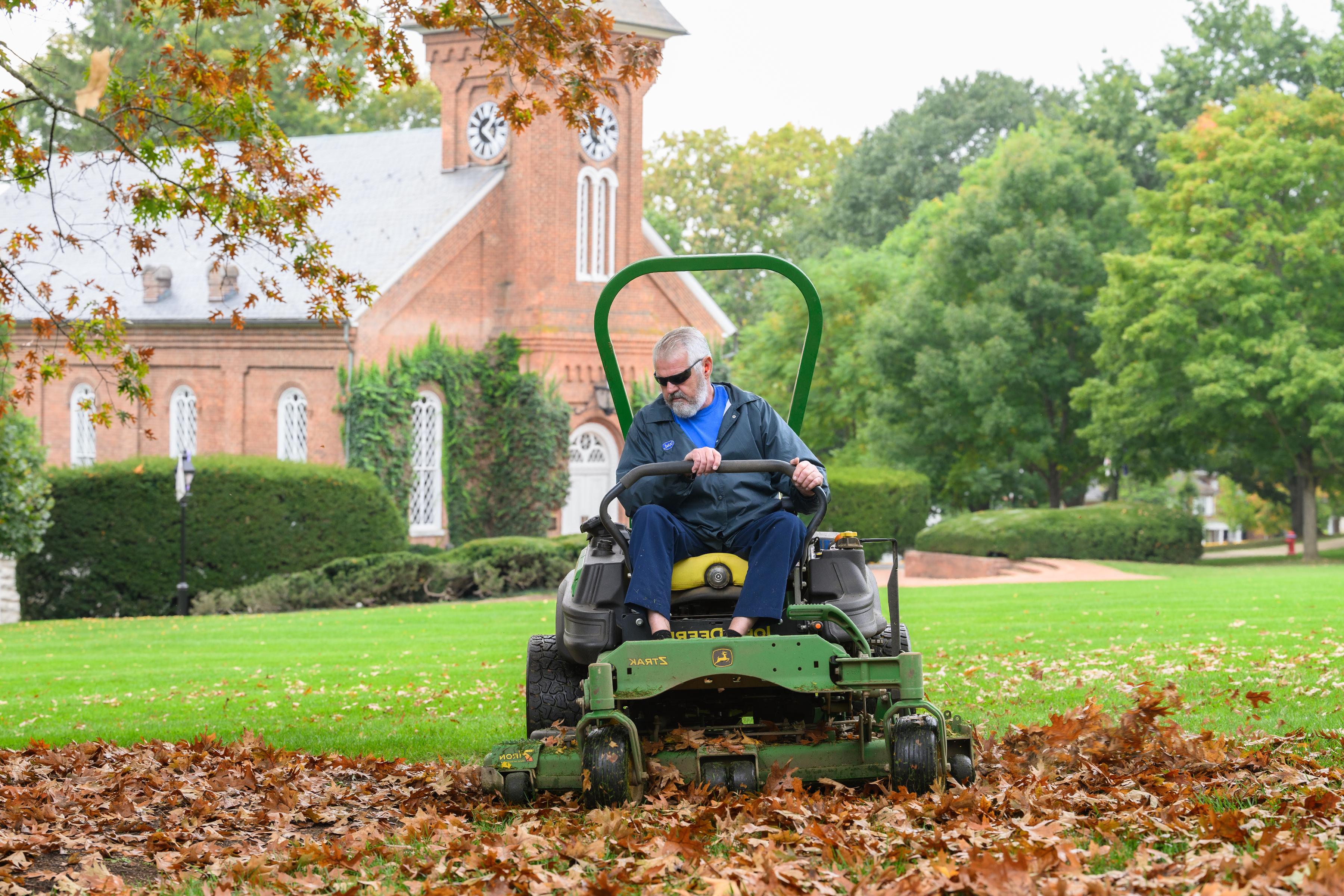 Grounds worker mows the Front Lawn